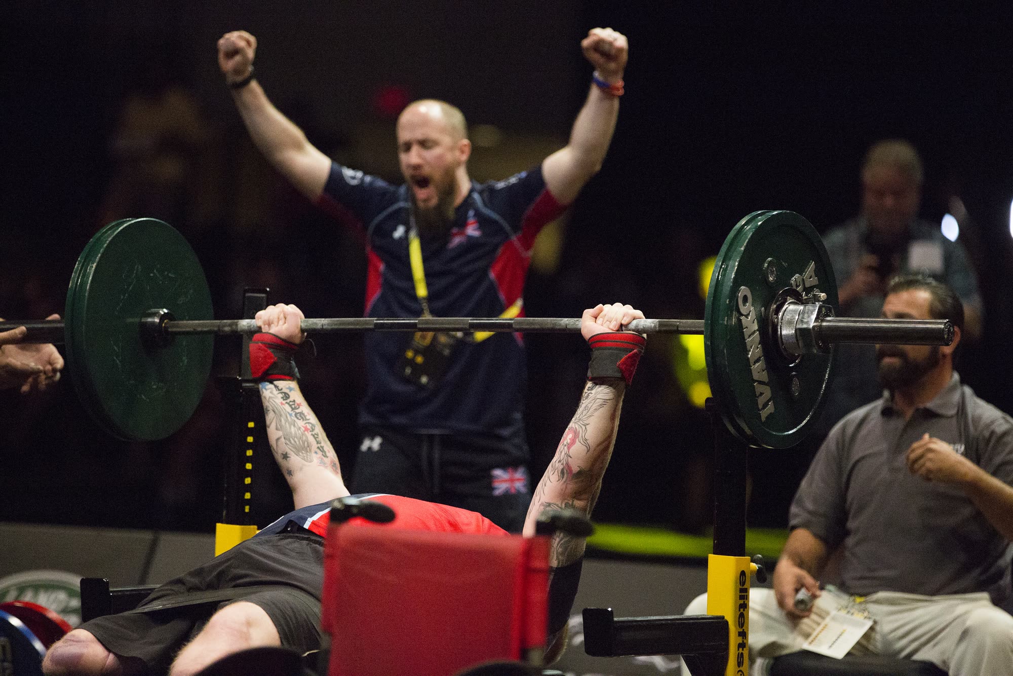 Athlete pressing a loaded barbell on the bench